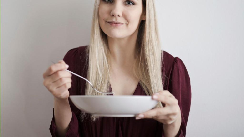 woman eating out of a bowl