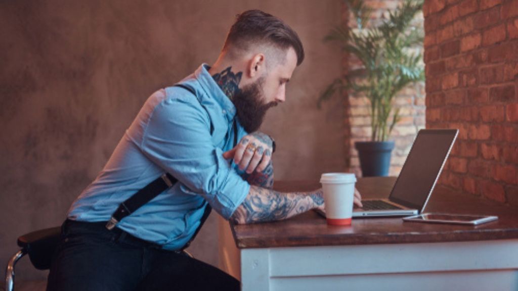 Tattooed man working
