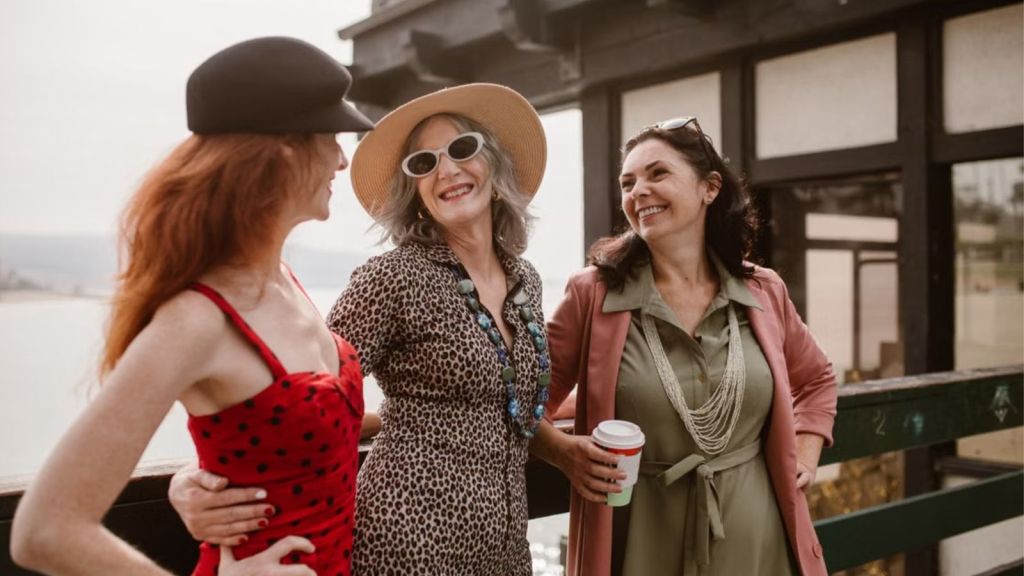 Three women talking and laughing outdoors