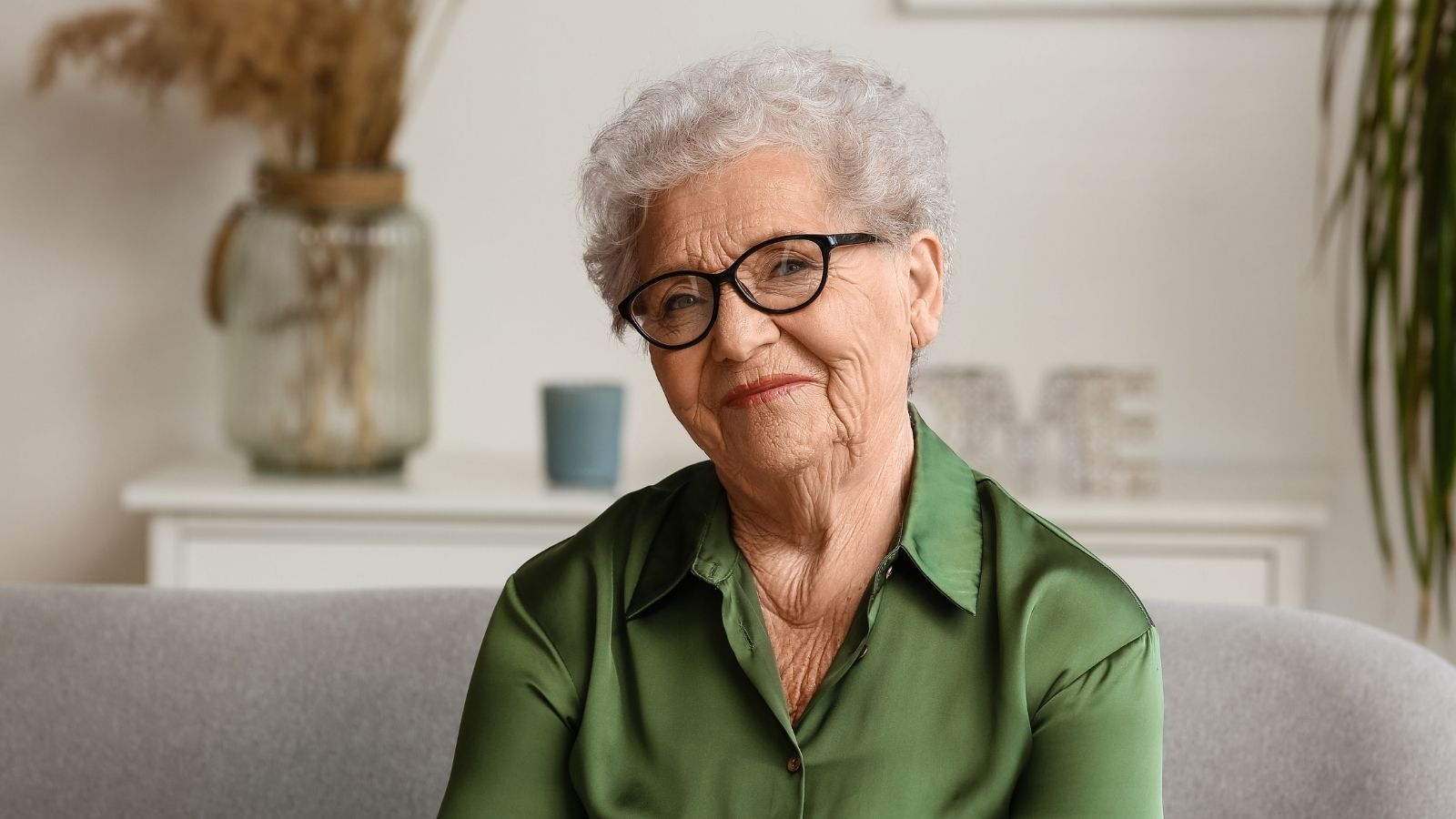 Their Elderly Neighbor Asks Them for Help All the Time. They Want to Start Saying No Without Making Her an Enemy. elderly woman wearing glasses and a green shirt