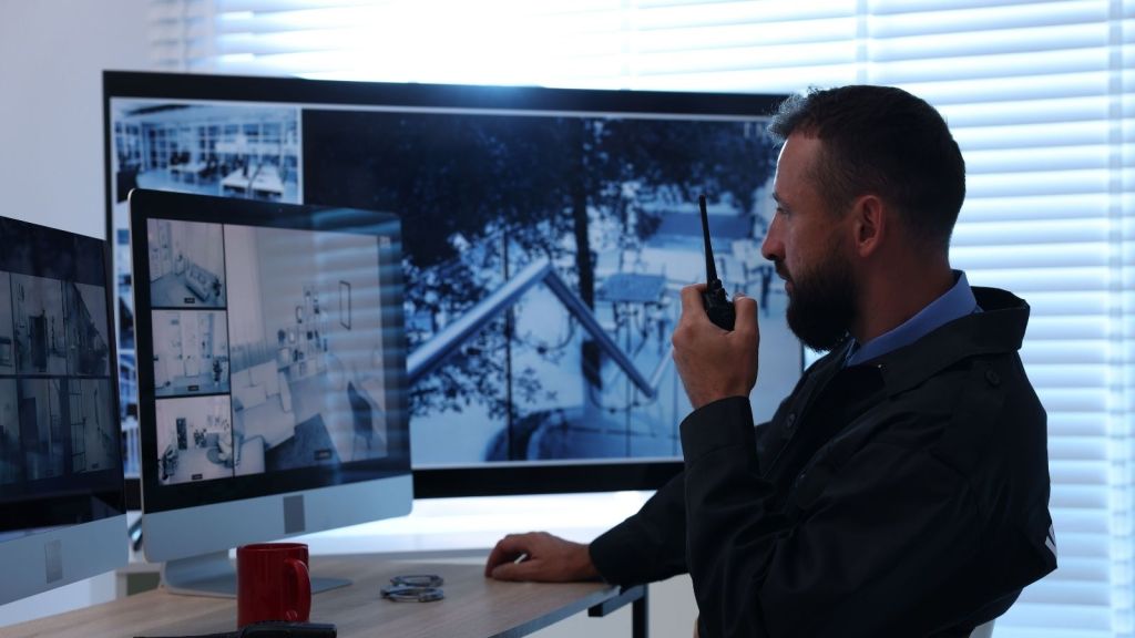 Security guard monitoring CCTV cameras