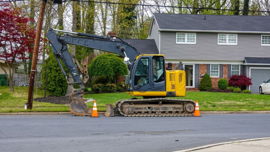 excavator in front of a house