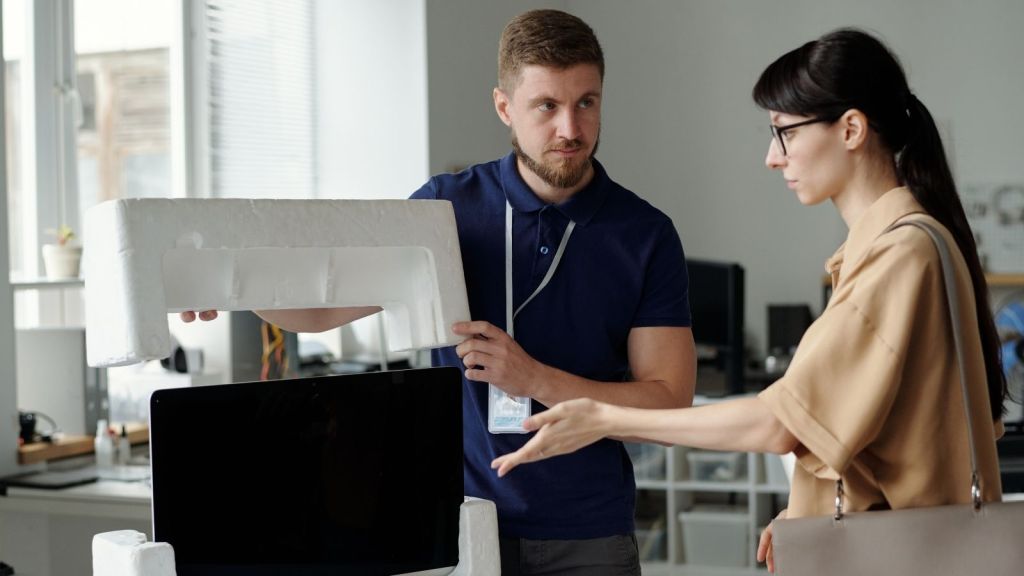 tech support worker unpacking a monitor