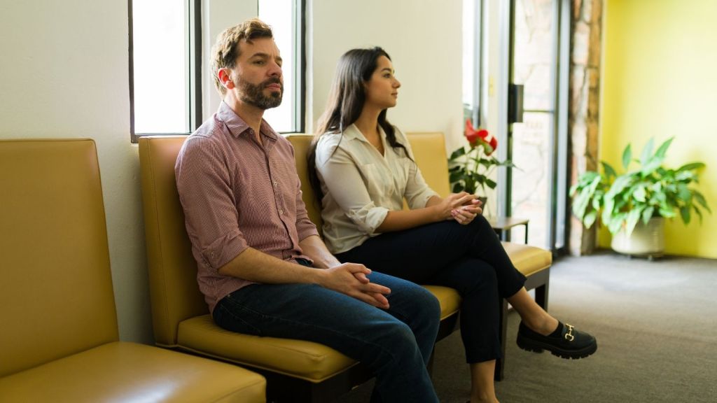 couple sitting in doctor's office waiting room