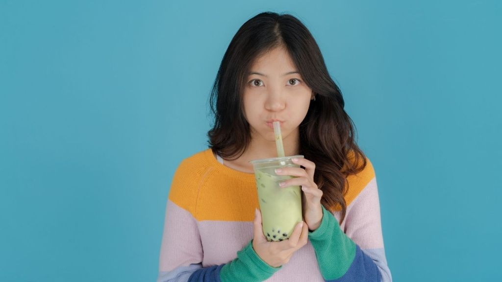 young woman drinking boba tea