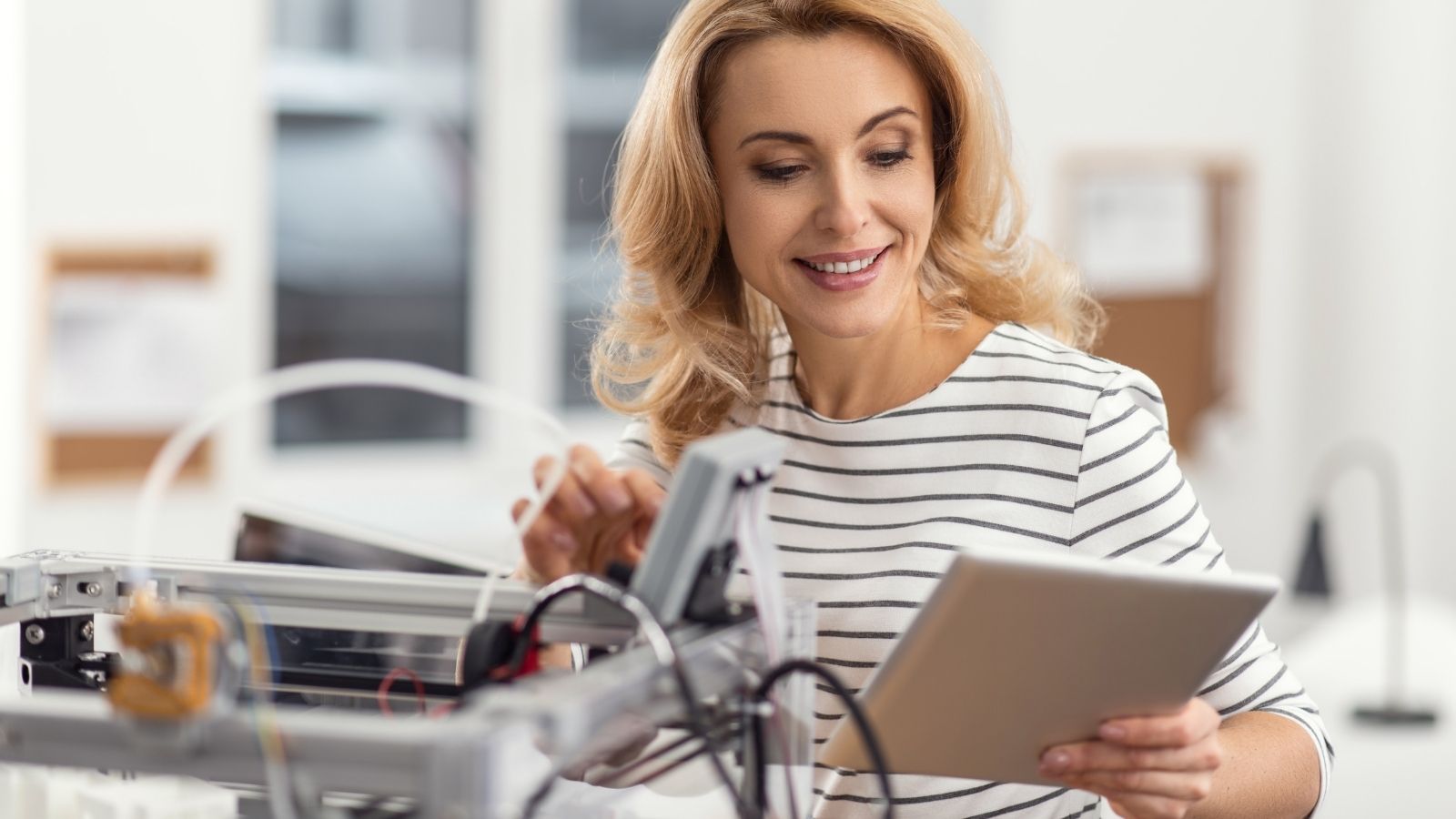 woman setting up a 3D printer