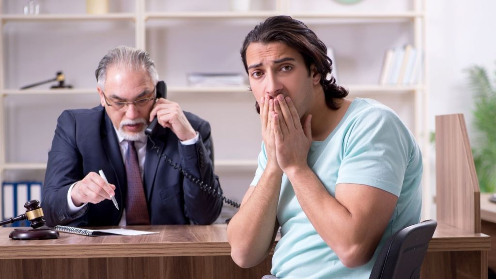 worried young man talking to a lawyer