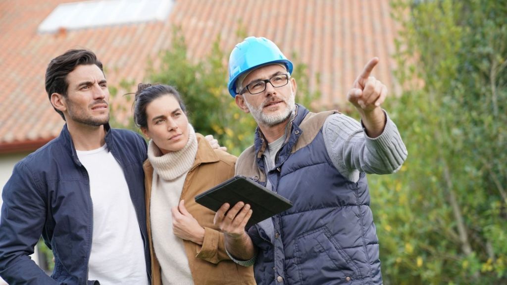 couple talking to construction worker