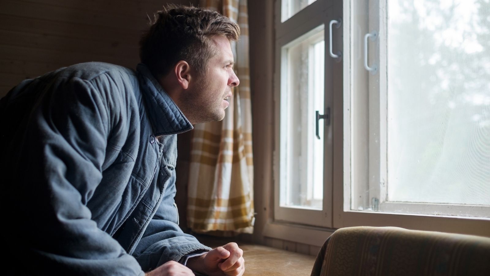 The Easement Trap: How a Routine Property Improvement Accidentally Sparked a High Stakes Suburban Legal Crisis upset man looking out the window
