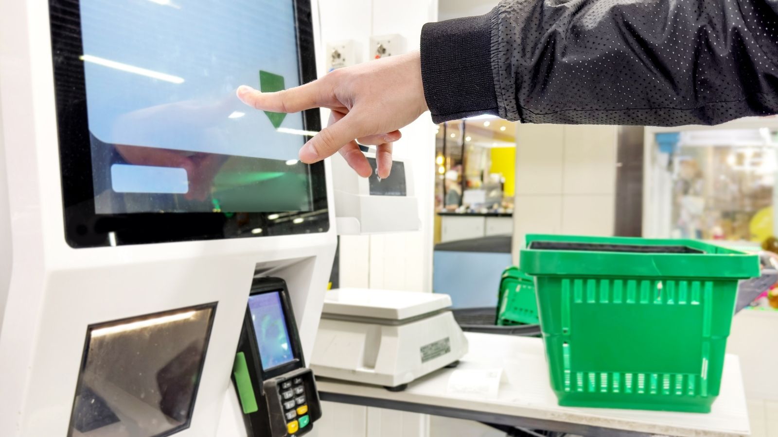 customer using self checkout at a grocery store