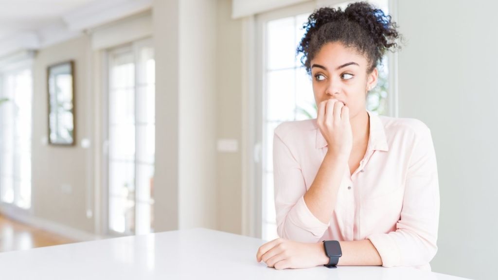 woman looking nervous in her apartment