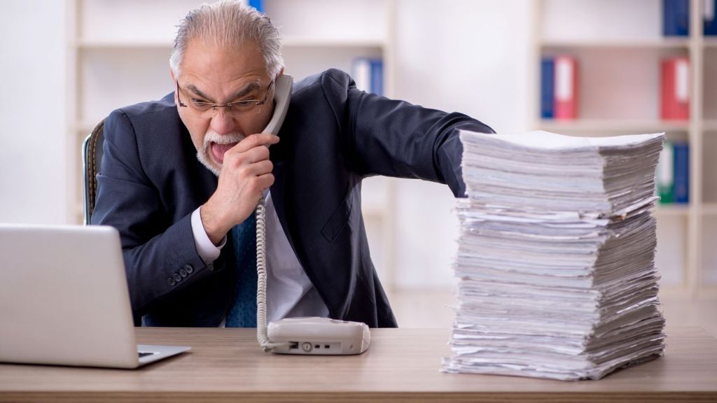 angry older businessman on the phone