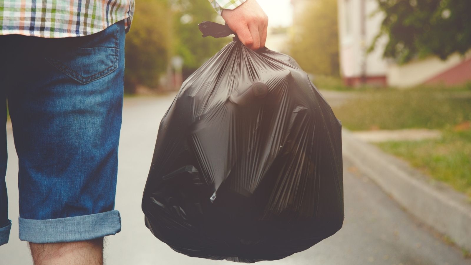 Teen Was Told to Load Luggage and Take Out Trash, Then He Accidentally Tossed Something Important young man carrying a black trash bag