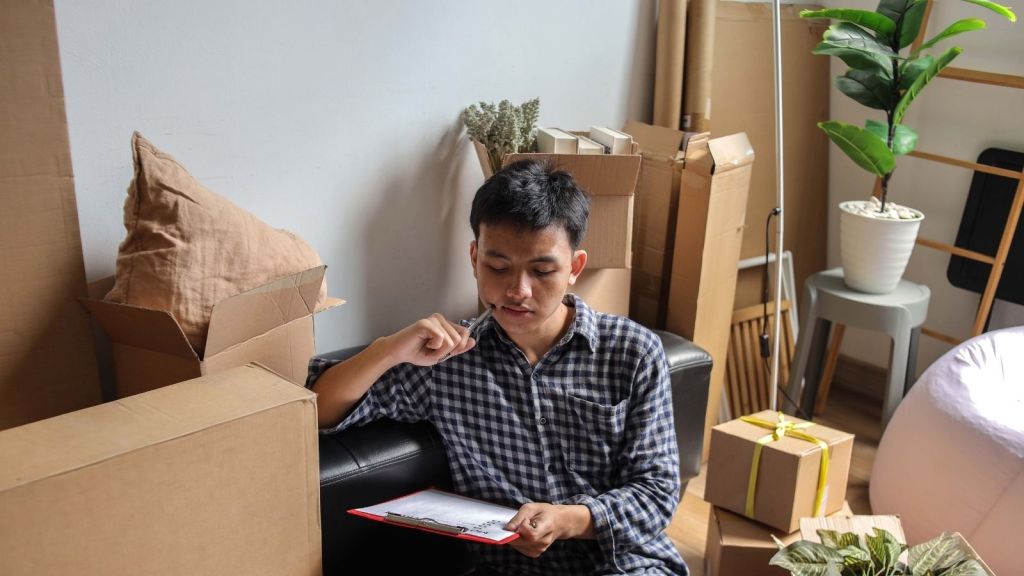 young man packing to move