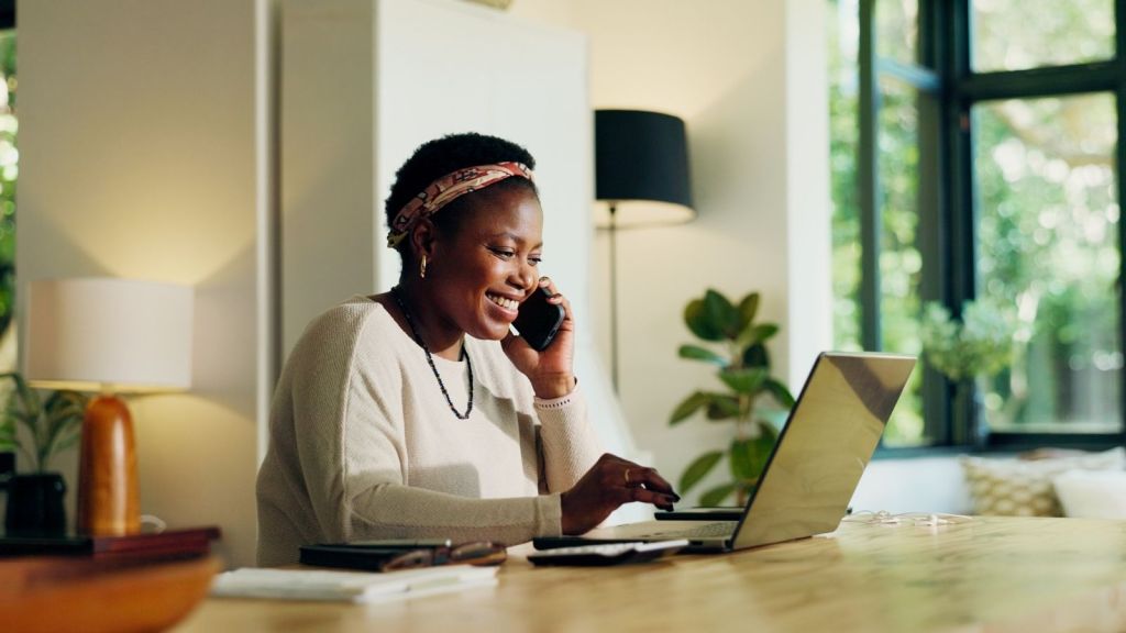 woman talking on the phone while working from home