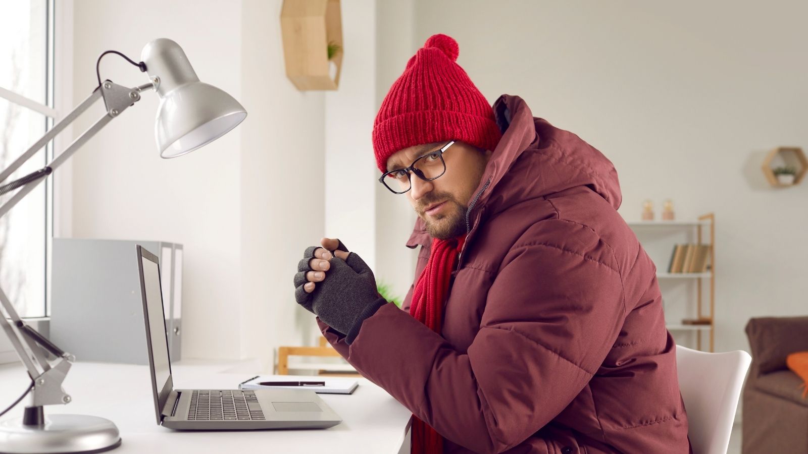 When the Power Grid Failed in the Dead of Winter, This Family Took a Radical Step to Keep Their Home Above Freezing man wearing a winter coat inside the house