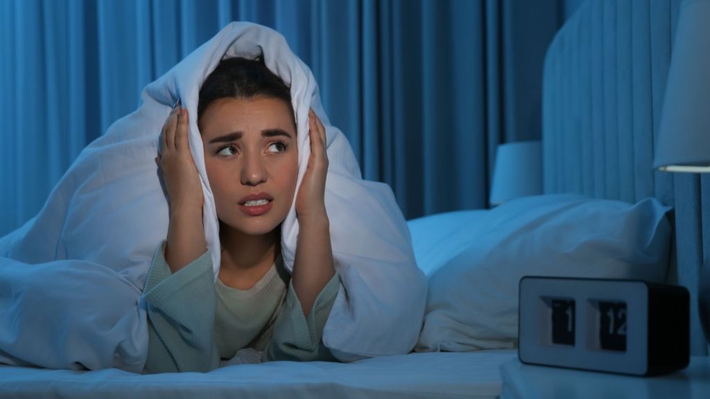 woman unable to sleep because of noisy neighbors
