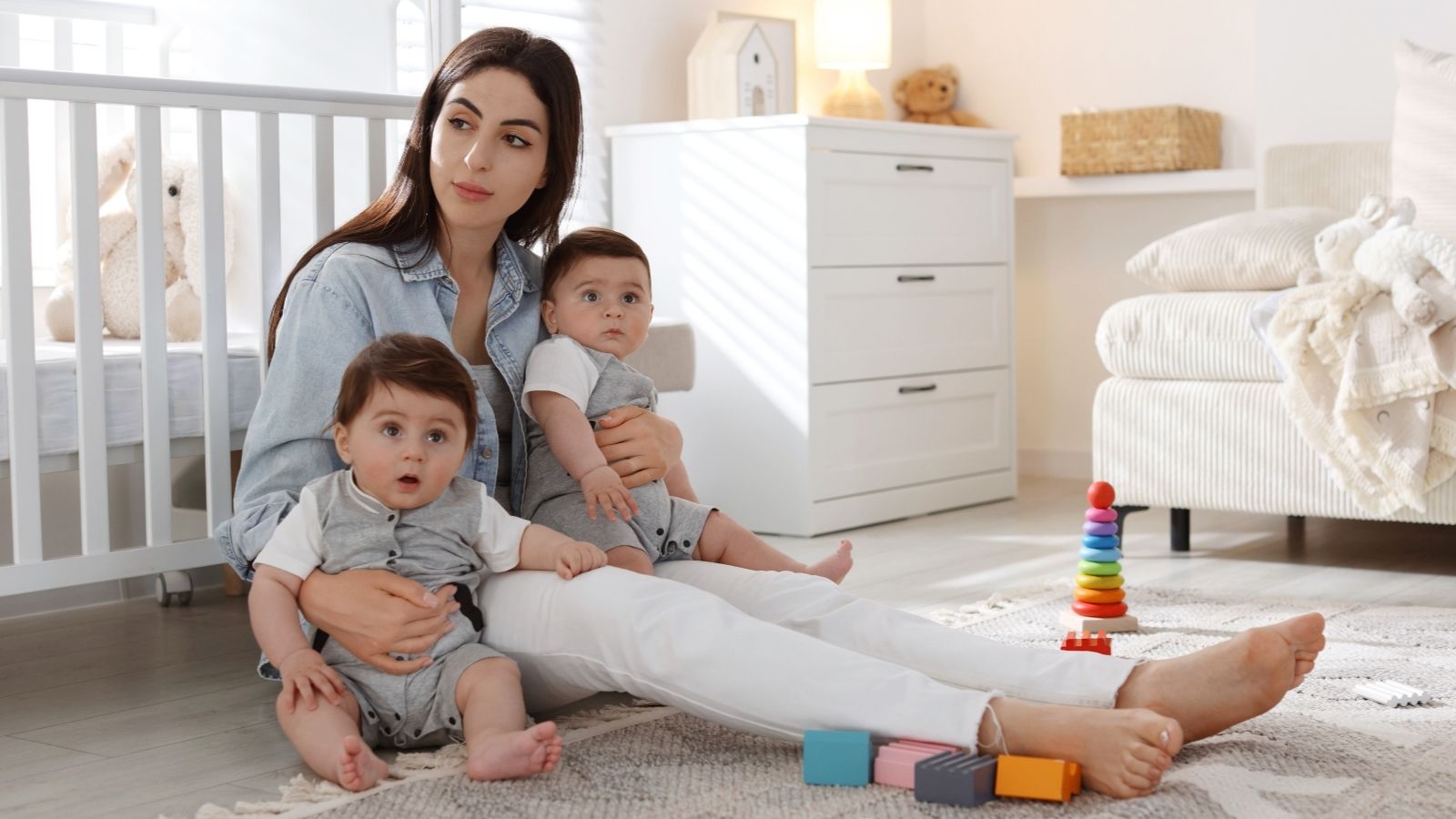 Three Painters Showed Up at the Same Time—One Took One Look and Walked Away woman sitting on the floor with twin babies
