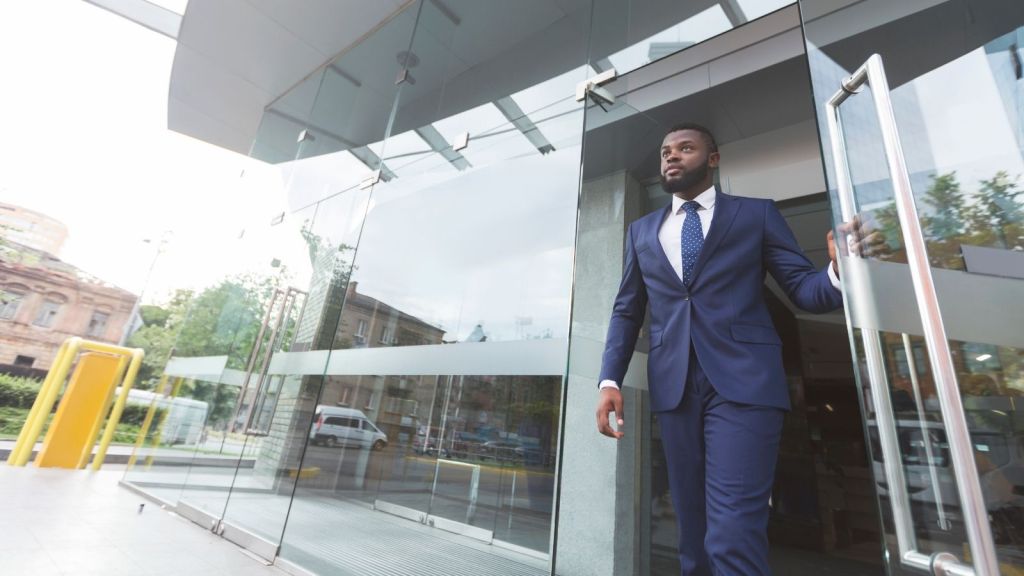 man walking out of an office building
