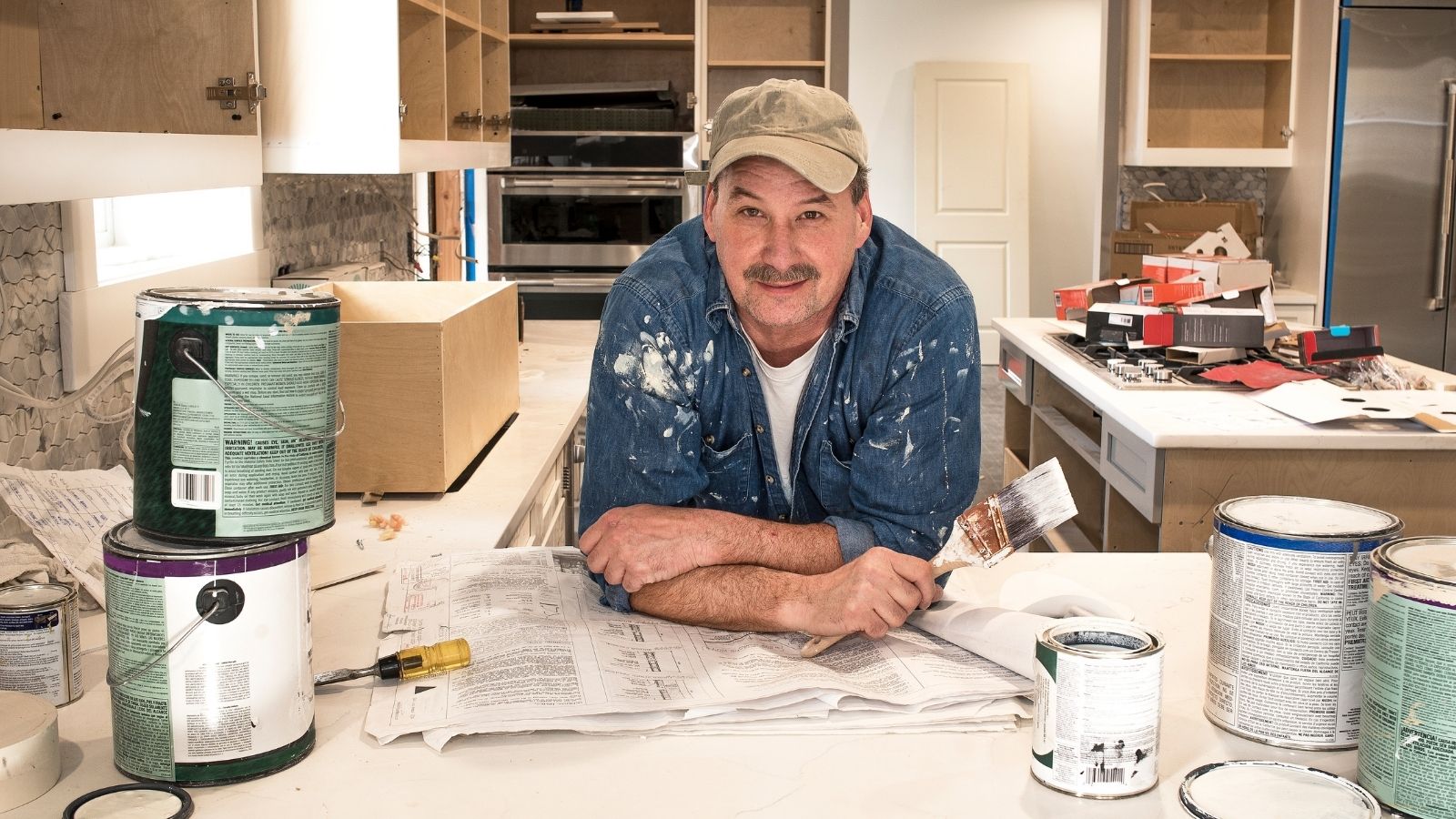 Her Father in Law Loved Helping Fix Up Their House, but Her Growing Nursery Timeline Couldnt Wait older man in the middle of a home renovation project