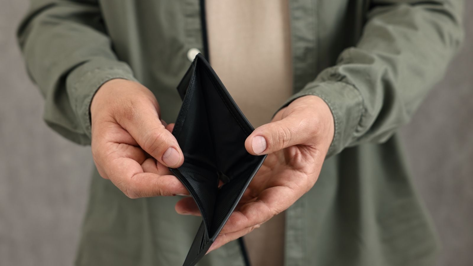 man showing an empty wallet