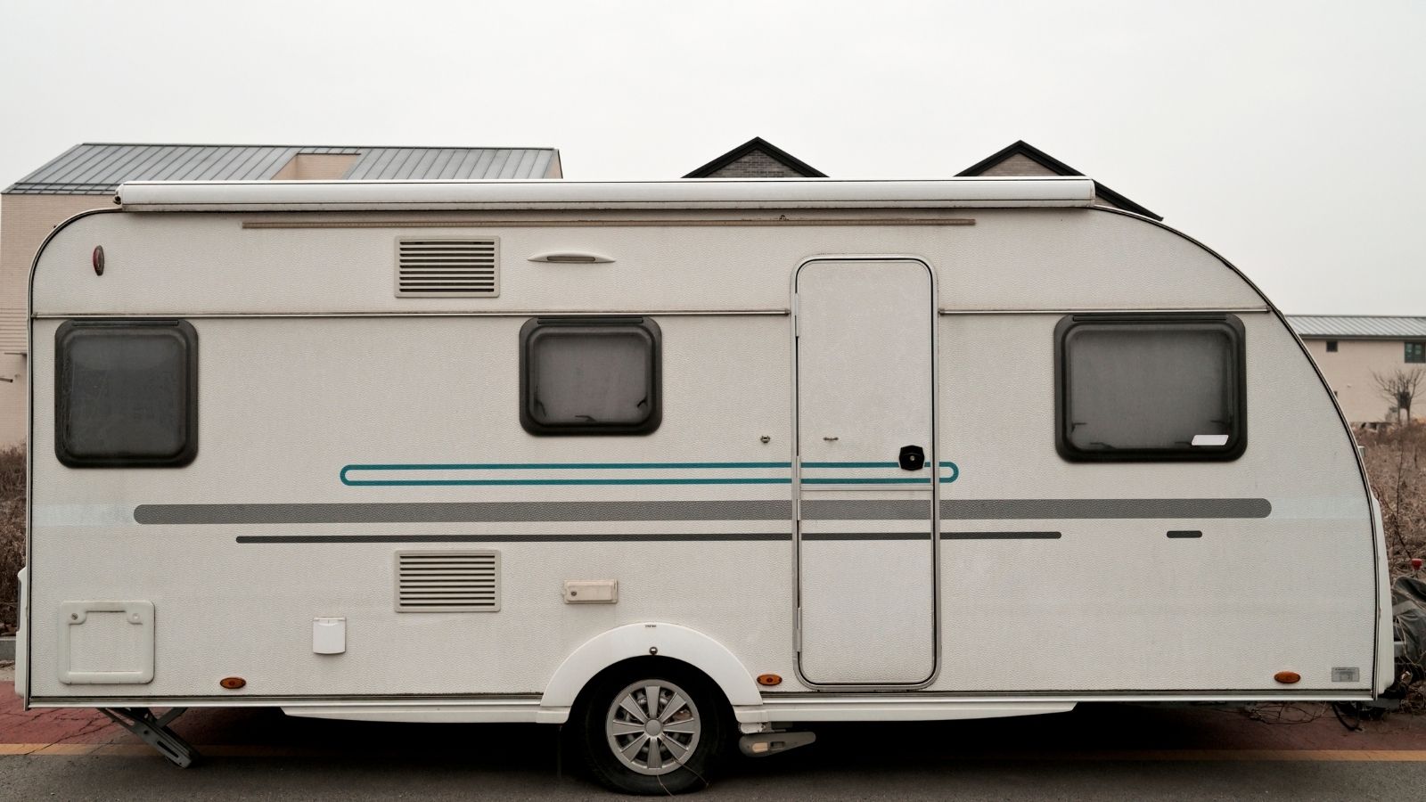 Their Neighbor Put Campers in the Street for Family to Live In—So They’re Thinking About Reporting It to the City camper parked on the street