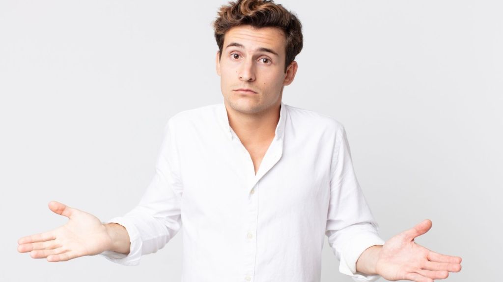 man in a white shirt shrugging