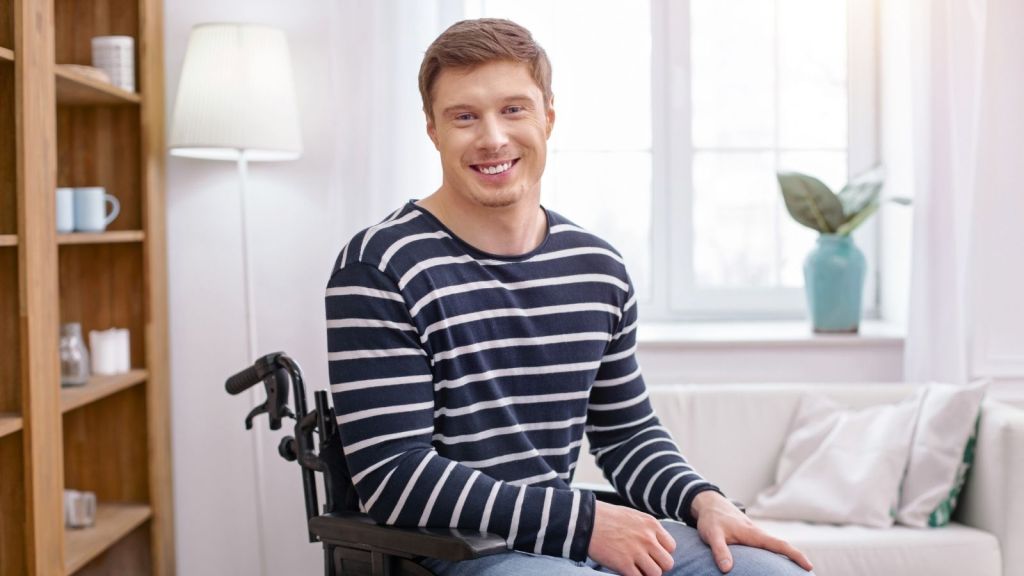 smiling man in a wheelchair