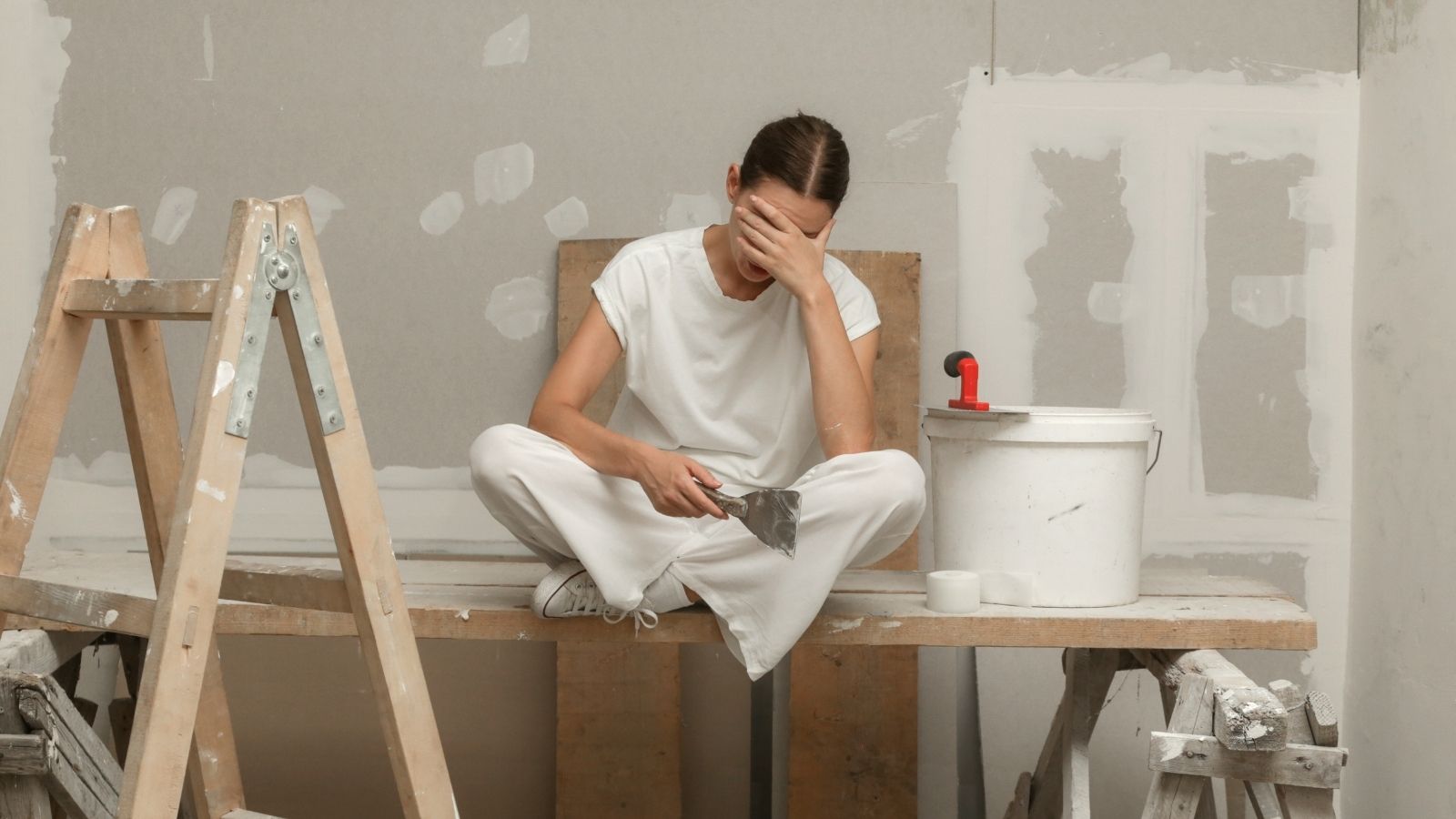 frustrated woman taking a break during a home renovation project