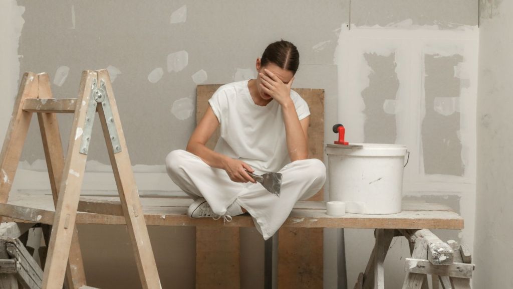 frustrated woman taking a break during a home renovation project