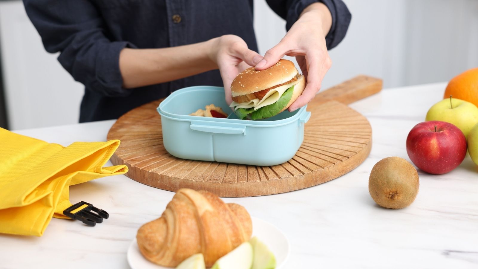 Why Is She Feeding Him?: Girlfriend Suspicious After Supervisor Starts Bringing Homemade Meals for Her Partner woman putting a sandwich in a lunchbox