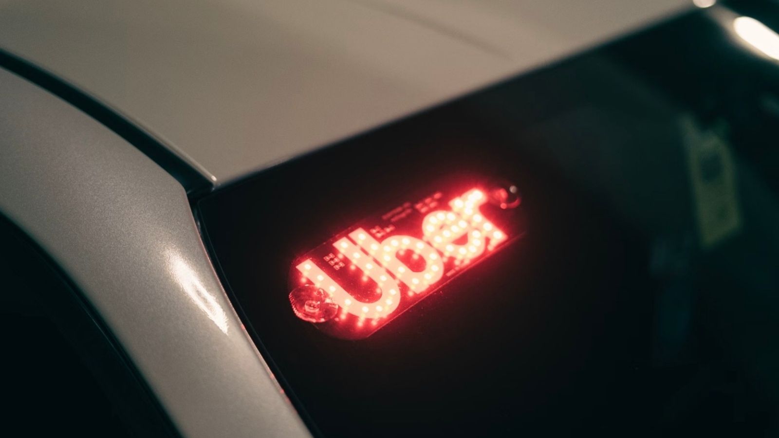 He Refused To Risk Parking Tickets—Then Turned The Problem Into Extra Income Uber sign in a white car