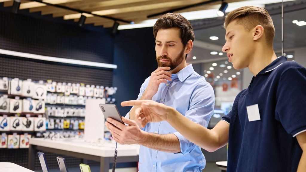 employee helping customer decide on a phone
