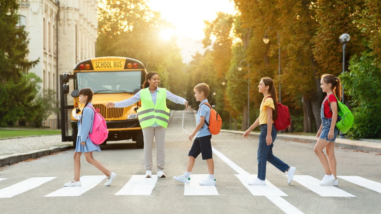 A School Told Him Not to Touch Crosswalk Signs Off the Clock. Minutes Later, a Kid Was Almost Hit. students crossing the street in a crosswalk