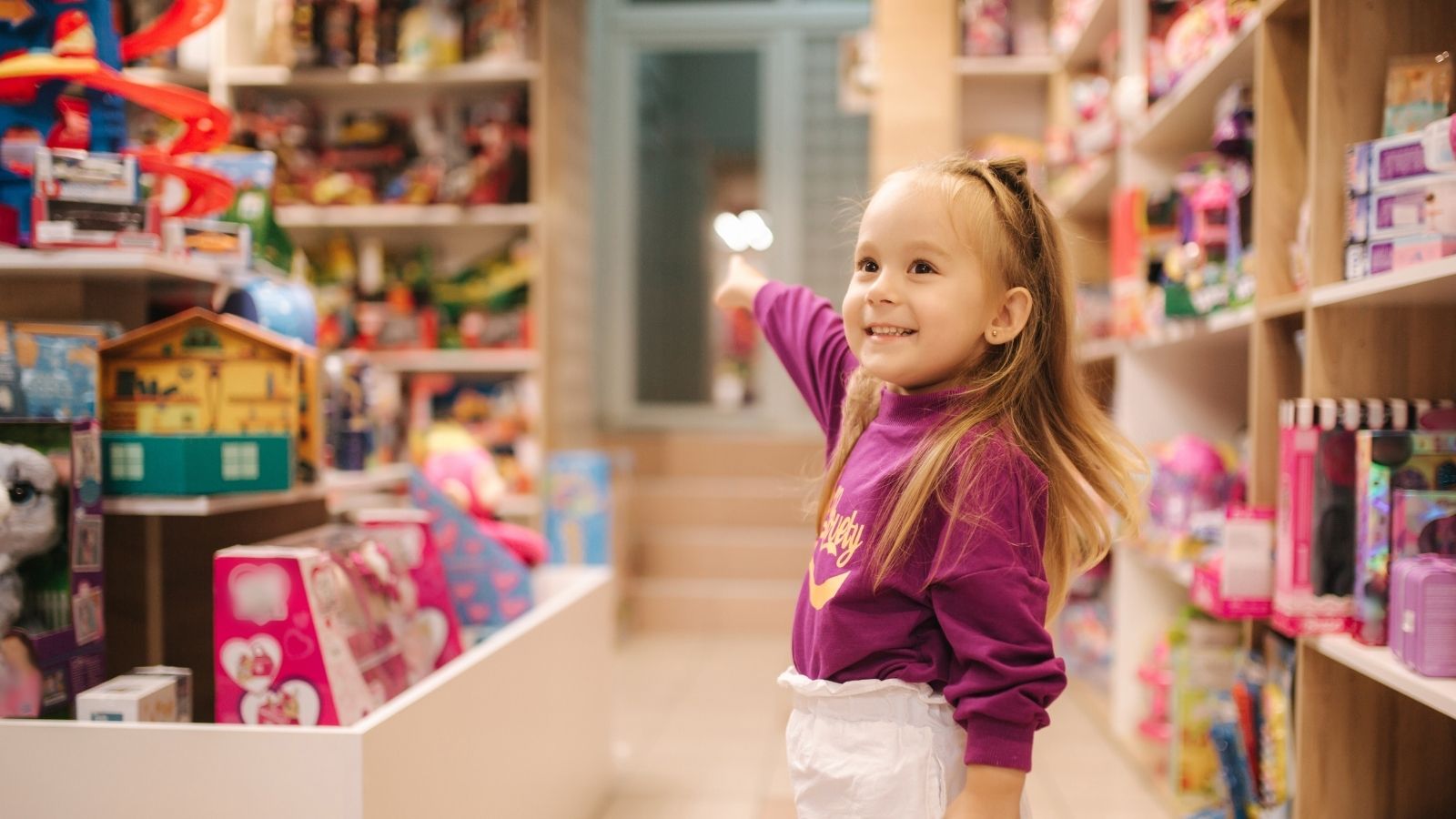 happy little girl in a toy store