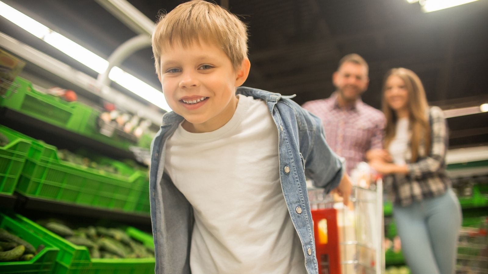 little boy in the grocery store with his parents
