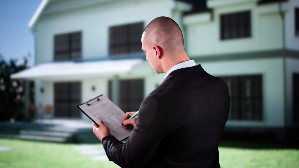 salesman in suit looking at a house
