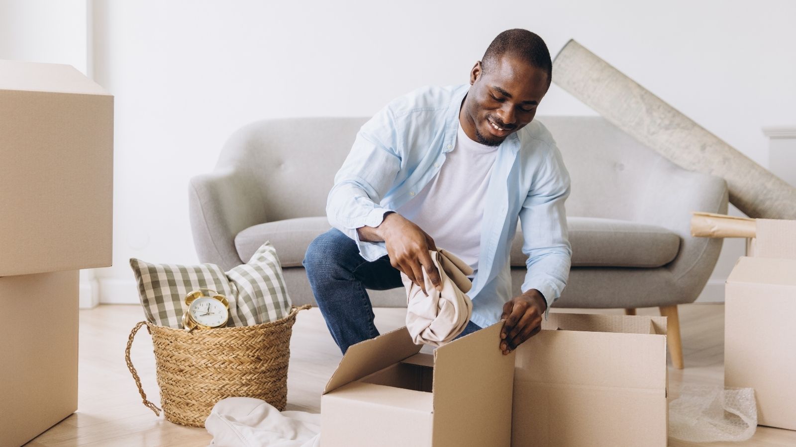 man packing moving boxes