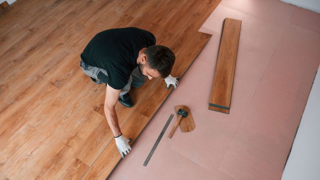man installing hardwood floors