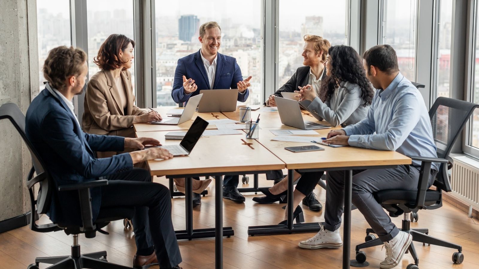 The CEO Wanted Layoffs to Cut Costs, But One Supervisor Found a Better Way and Nobody Lost Their Job employees in a business meeting