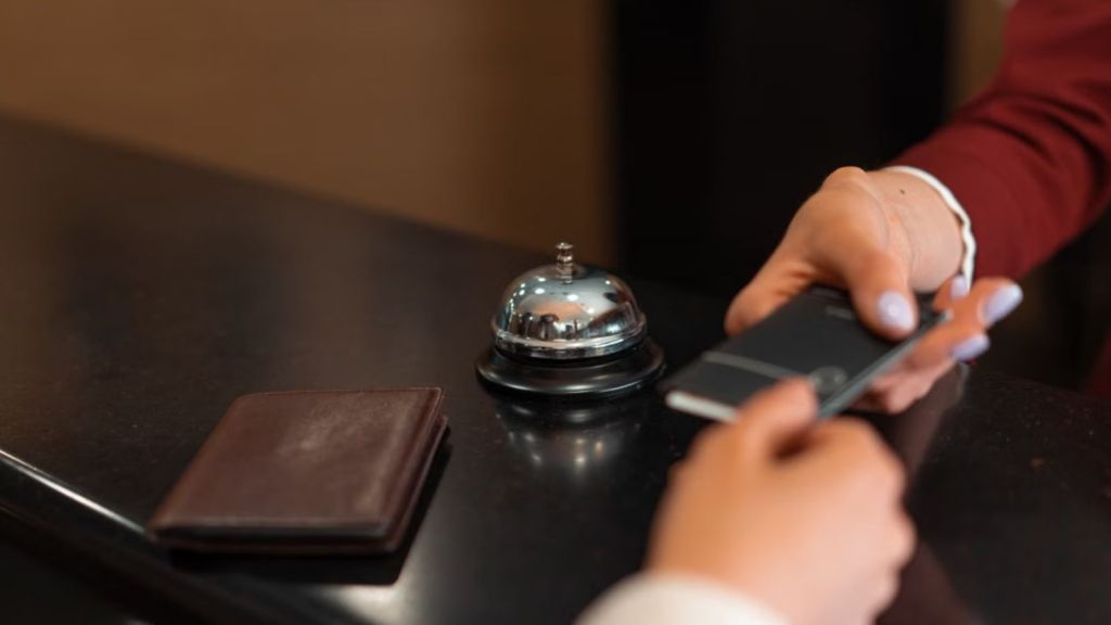 Hotel front desk officer handing over the hotel key card to the guest