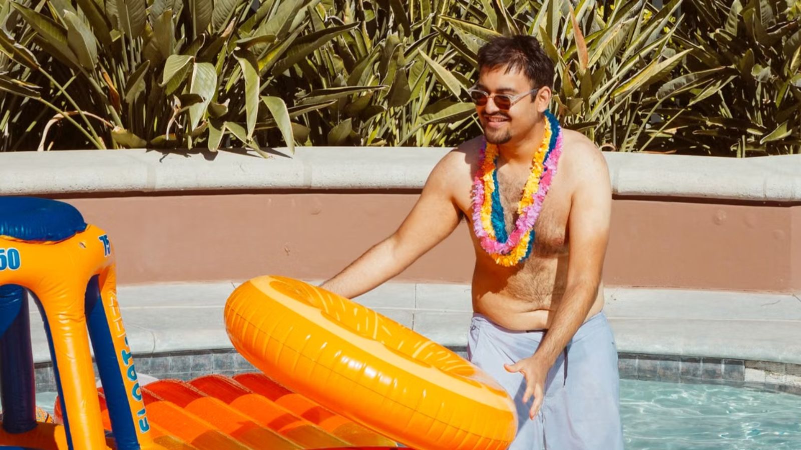 A Stranger Called Him Rafiki at a Resort Pool and Started Ordering Him Around — He Put Him in His Place Immediately Asian guy smiling and having fun in the swimming pool