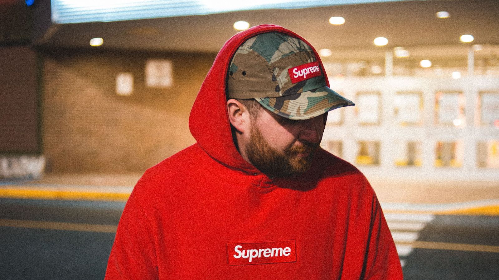 He Made the Ultimate Mistake of Wearing a Red Hoodie to Target. The Hilariously Awkward Confrontation That Followed in the Aisles. Man with a cap and red hoodie walking outside a shopping center
