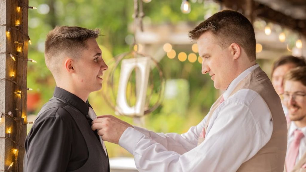 Groomsmen supporting and assisting groom on his wedding day