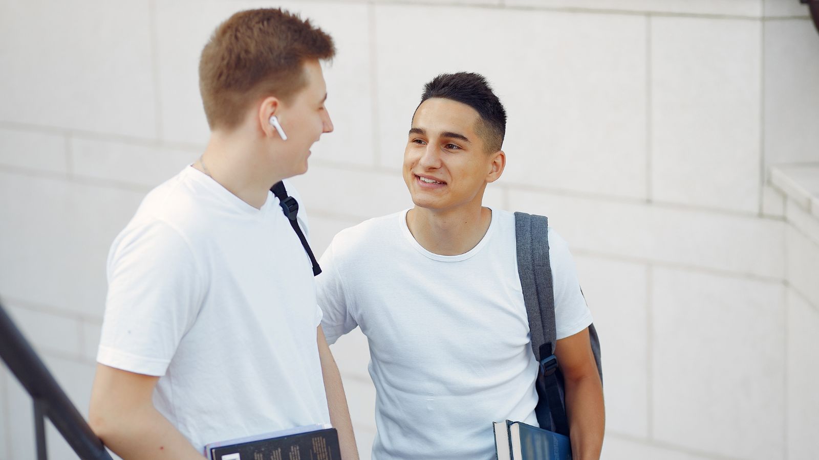 He Tried to Help His Friend Find a Prom Date by Asking a Random Girl — She Said No and Things Got Very Awkward Very Fast 2 male students talking outdoors