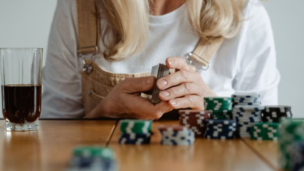 Elderly woman engaging in a poker game with chips and cards