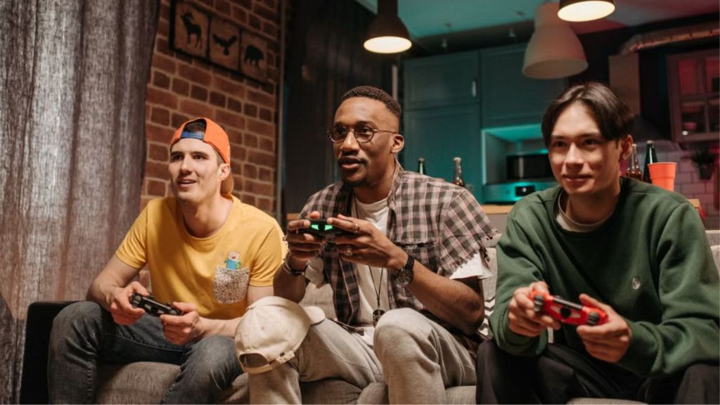 3 young men playing video games at home