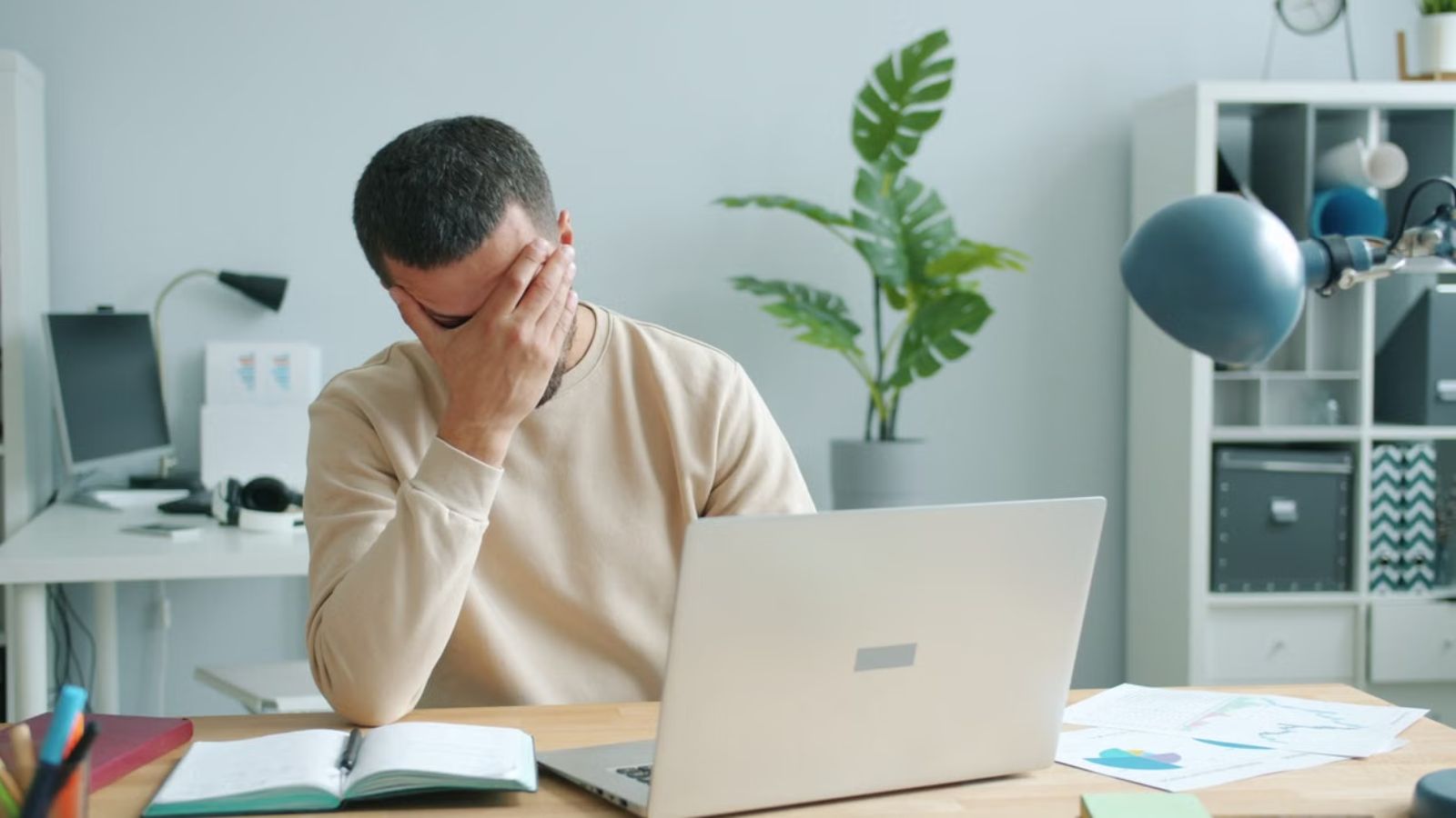 New Nonprofit Employee Feels Unneeded After Boss Automates Much of His Work With AI Frustrated worker in front of his laptop with his hands covering his face