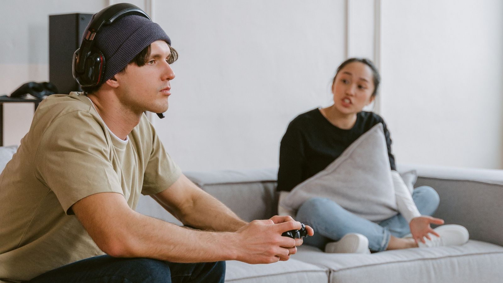 Man Unwinds With Video Games and TV After Work, but His Roommate Says He’s Not Interested in Her Life Woman talking to a man who is playing video games