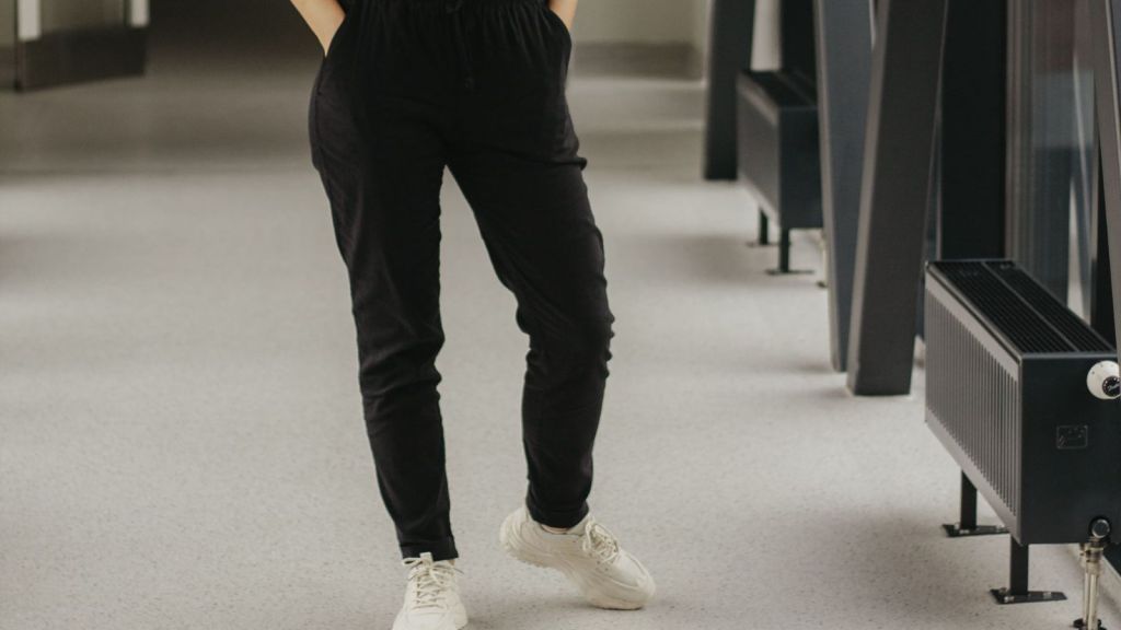 Person wearing black pants on a hospital hallway